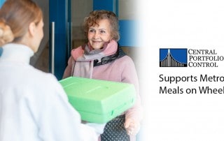 Volunteer delivering a meal to door of senior citizen